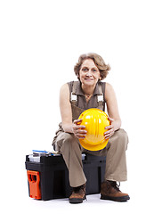 Image showing Senior woman sitting in a toolbox
