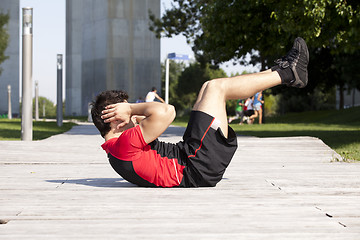 Image showing Athlete man making abdominals