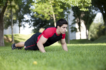 Image showing Athlete man making pushups