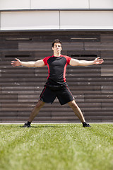 Image showing Athlete warming and stretching