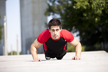 Image showing Athlete man making pushups