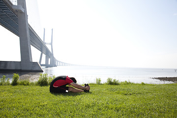 Image showing Athlete warming and stretching