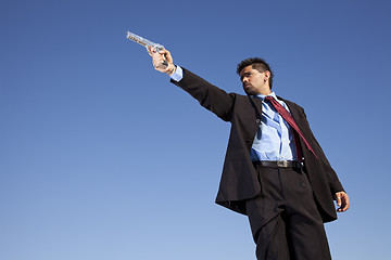 Image showing Businessman aiming a handgun