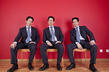 Image showing Three twin businessman waiting