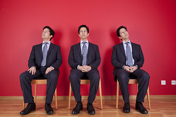 Image showing Three twin businessman waiting