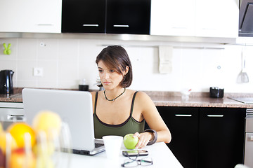 Image showing Modern woman reading e-mails at her breakfast