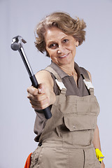 Image showing Senior woman with a hammer