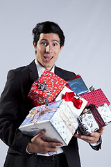 Image showing Businessman with many gift packages