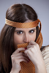 Image showing Woman hidding behind a necktie