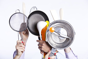 Image showing Hands holding kitchenware tools
