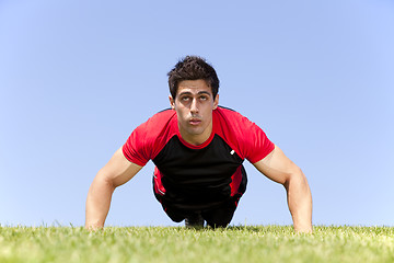 Image showing Athlete man making pushups