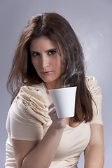 Image showing Woman drinking a hot drink