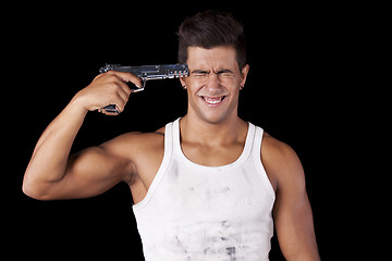 Image showing Man aiming a handgun at his head