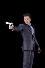 Image showing Businessman aiming a handgun