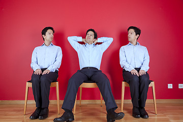 Image showing Three twin businessman waiting