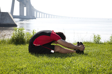 Image showing Athlete warming and stretching