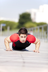 Image showing Athlete man making pushups