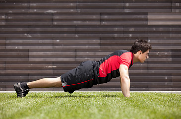 Image showing Athlete man making pushups