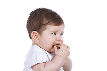 Image showing Baby boy eating a cookie