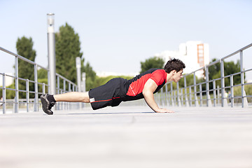 Image showing Athlete man making pushups