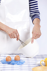 Image showing Hands mixing eggs