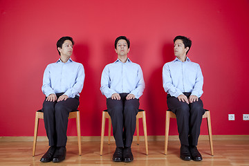 Image showing Three twin businessman waiting