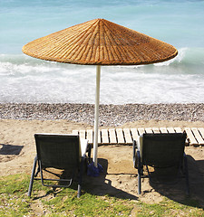 Image showing Beach chairs and umbrella