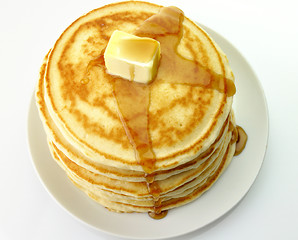 Image showing pancakes with butter and maple syrup.