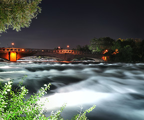 Image showing mountain river with bridge at the night time