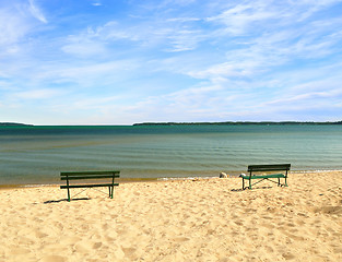 Image showing empty beach with benches 