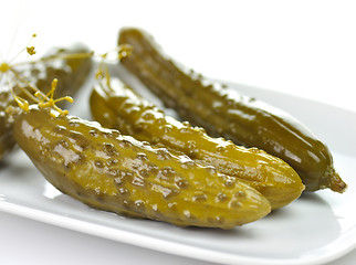 Image showing dill pickles on a white dish