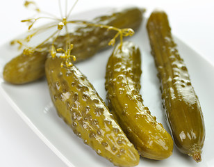 Image showing dill pickles on a white dish 