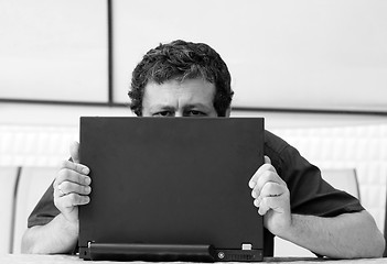 Image showing Man's eyes over laptop