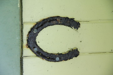 Image showing rusty horse shoe on wall