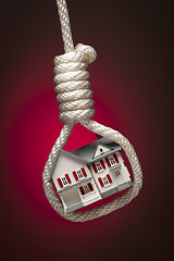 Image showing House Tied Up and Hanging in Hangman's Noose on Red