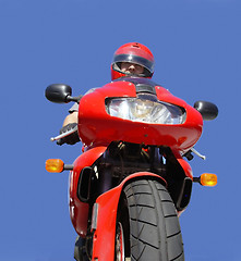 Image showing Man on a red bike