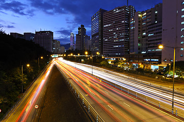 Image showing light trails on modern city at night