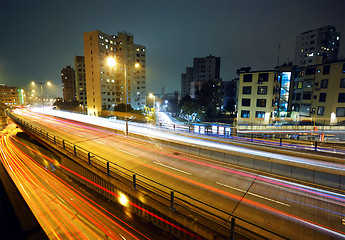 Image showing light trails on modern city at night