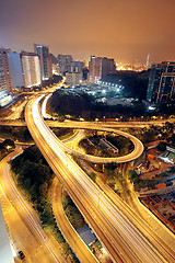 Image showing Freeway in night with cars light in modern city. 