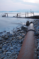 Image showing old metal pipe and road to sea