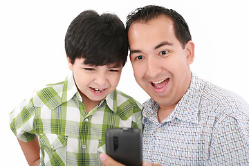 Image showing Young father and son was surprised, having read on mobile phone 