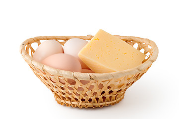 Image showing Eggs and cheese lay in a woven basket