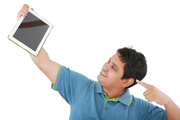 Image showing Laughing casual young man holding a touch pad tablet pc on isola