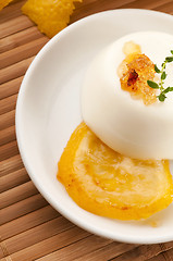 Image showing Vanilla Panna Cotta Dessert with lemon and fresh herbs