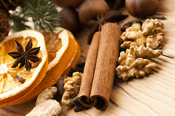 Image showing Different kinds of spices, nuts and dried oranges - christmas de