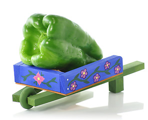 Image showing decorative blue wheelbarrow with green pepper 