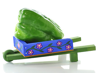 Image showing decorative blue wheelbarrow with green pepper