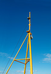 Image showing Yellow mast on blue background