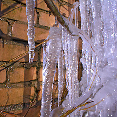 Image showing blue icicles near brick wall