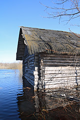 Image showing rural wooden house amongst spring flood